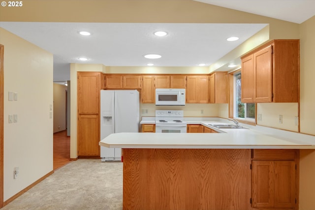 kitchen featuring lofted ceiling, sink, light colored carpet, kitchen peninsula, and white appliances