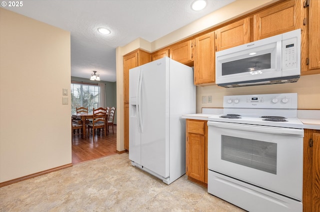 kitchen featuring white appliances and a textured ceiling