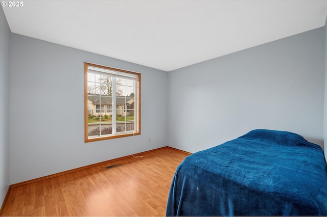 bedroom with hardwood / wood-style flooring