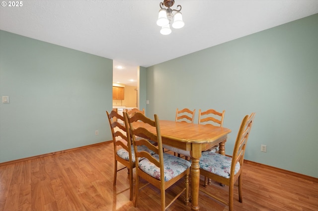 dining area with light hardwood / wood-style floors