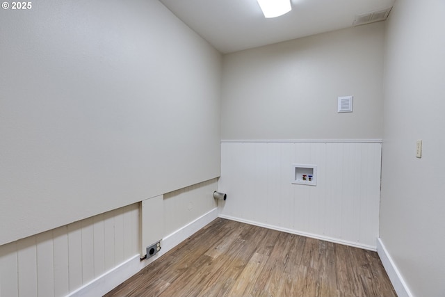 washroom with washer hookup, laundry area, wood finished floors, and visible vents