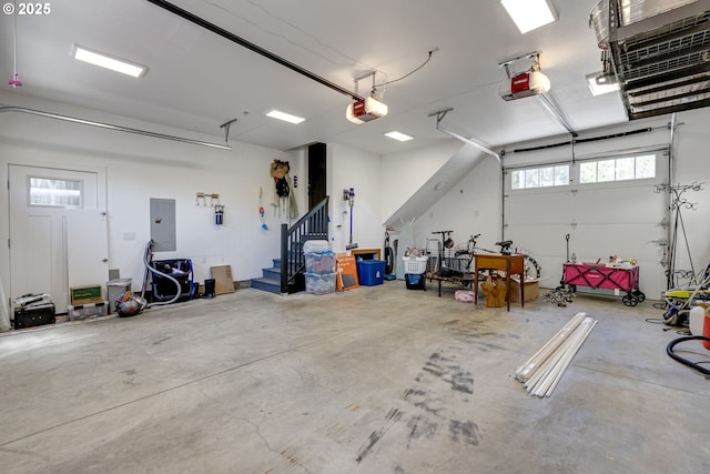 garage with electric panel, a garage door opener, and a heating unit