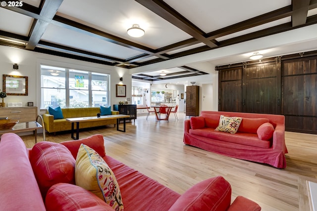 living room with a barn door, coffered ceiling, light wood finished floors, and beam ceiling