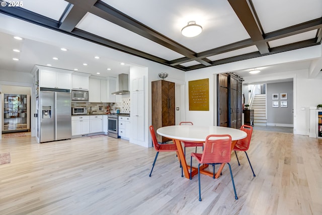 dining room with stairs, light wood-style floors, a toaster, and coffered ceiling