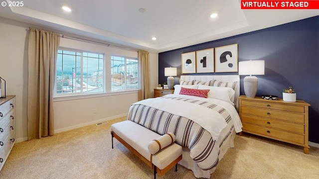 carpeted bedroom featuring a raised ceiling