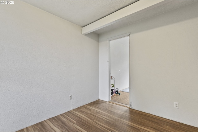 unfurnished room with wood finished floors