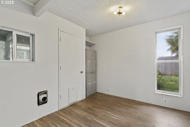 unfurnished bedroom with wood finished floors and a textured ceiling