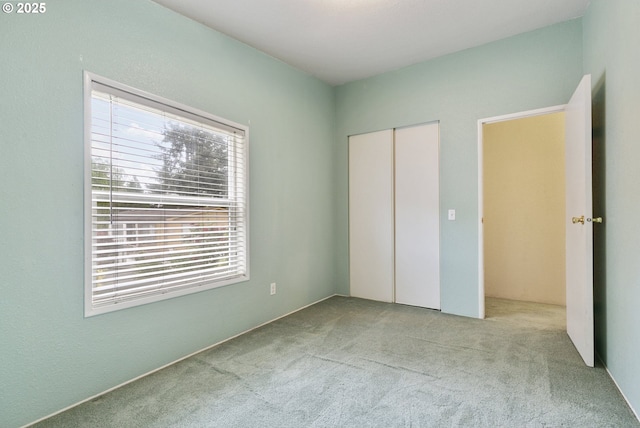 unfurnished bedroom with carpet floors and a closet