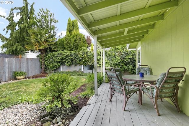 deck featuring a fenced backyard and outdoor dining space
