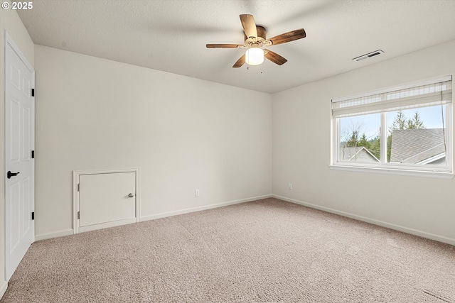 empty room featuring carpet and ceiling fan