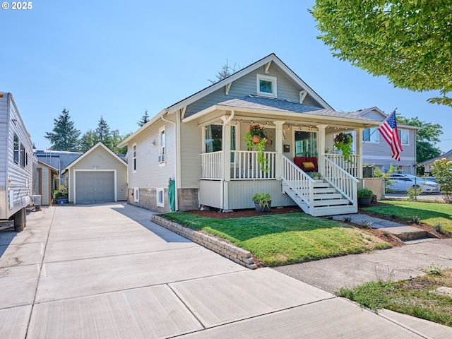 bungalow with a porch, a front yard, an outdoor structure, and a garage