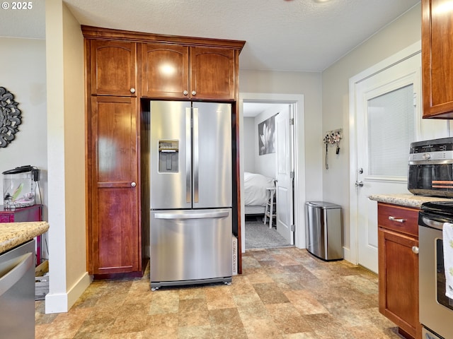 kitchen with stainless steel appliances and a textured ceiling