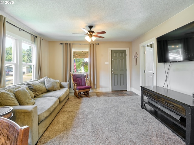 living room with a textured ceiling, plenty of natural light, and ceiling fan