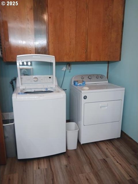 58474 Old Lake Rd, Christmas Valley, OR 97641 - laundry room with separate washer and dryer, cabinet space, and wood finished floors