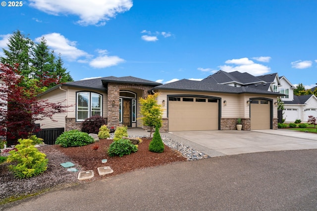1825 NW Tanner Ct, Camas, WA 98607 - view of front facade featuring a garage, concrete driveway, and stone siding