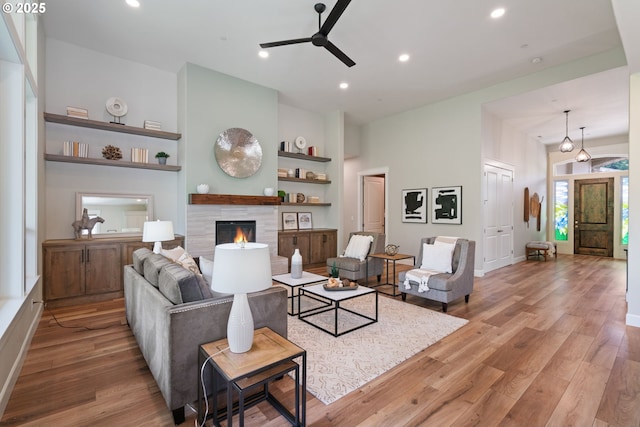 1825 NW Tanner Ct, Camas, WA 98607 - living area featuring ceiling fan, light wood-type flooring, a fireplace, built in features, and recessed lighting