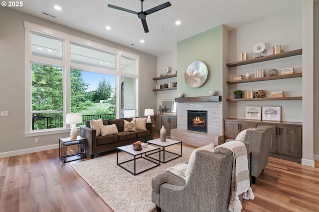 1825 NW Tanner Ct, Camas, WA 98607 - living area with a ceiling fan, a tiled fireplace, wood finished floors, plenty of natural light, and recessed lighting