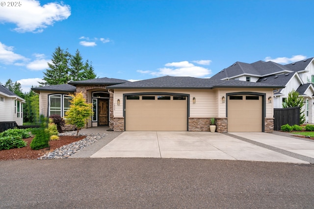 1825 NW Tanner Ct, Camas, WA 98607 - prairie-style home with an attached garage, stone siding, concrete driveway, and roof with shingles
