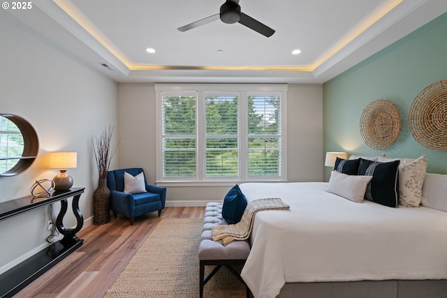 1825 NW Tanner Ct, Camas, WA 98607 - bedroom featuring a raised ceiling, wood finished floors, baseboards, a ceiling fan, and recessed lighting