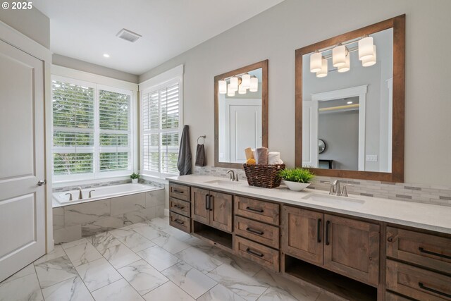 1825 NW Tanner Ct, Camas, WA 98607 - bathroom with double vanity, a bath, marble finish flooring, recessed lighting, and tasteful backsplash