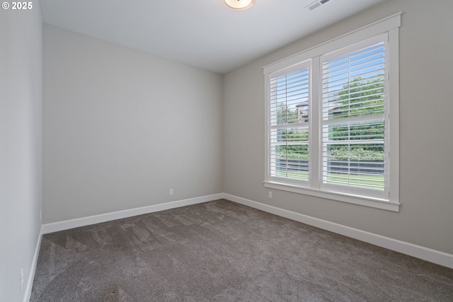 1825 NW Tanner Ct, Camas, WA 98607 - unfurnished room with plenty of natural light, dark colored carpet, and baseboards