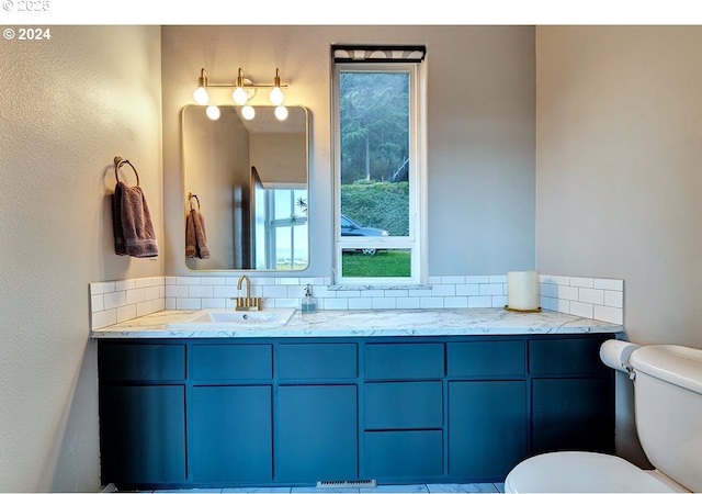 12508 NW Mountain View Rd, Portland, OR 97231 - bathroom featuring toilet, a textured wall, a healthy amount of sunlight, and vanity