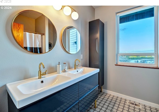 12508 NW Mountain View Rd, Portland, OR 97231 - bathroom featuring double vanity, baseboards, and a sink
