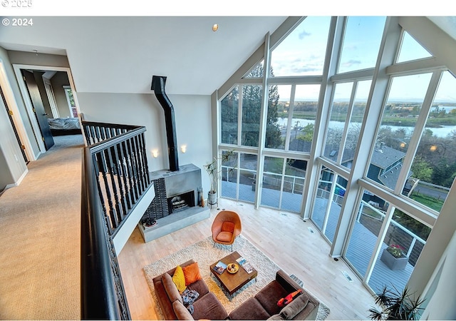 12508 NW Mountain View Rd, Portland, OR 97231 - unfurnished living room with a water view, floor to ceiling windows, a healthy amount of sunlight, and wood finished floors