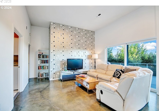 12508 NW Mountain View Rd, Portland, OR 97231 - living area featuring visible vents, finished concrete flooring, and a towering ceiling
