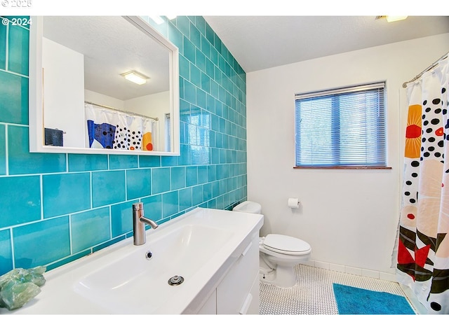 12508 NW Mountain View Rd, Portland, OR 97231 - full bath with tile walls, tile patterned flooring, vanity, and toilet