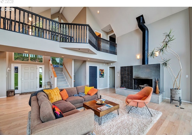 12508 NW Mountain View Rd, Portland, OR 97231 - living area featuring stairs, wood finished floors, and high vaulted ceiling