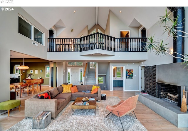 12508 NW Mountain View Rd, Portland, OR 97231 - living area featuring baseboards, wood finished floors, stairway, and a towering ceiling