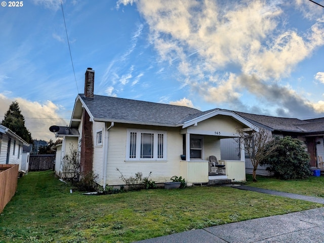 bungalow-style home featuring a porch and a front lawn