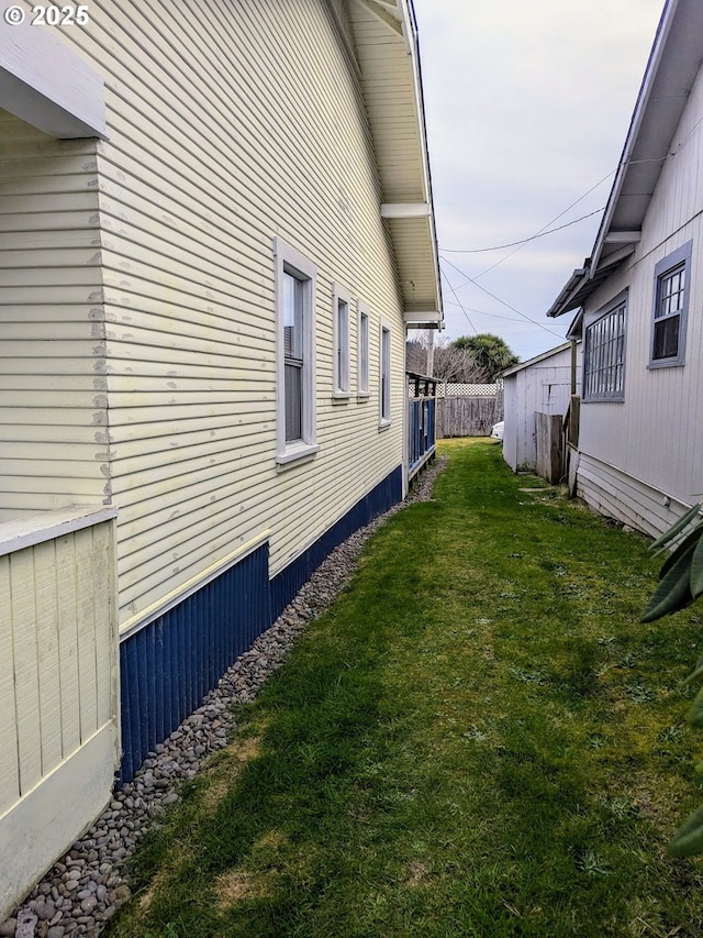 view of side of home featuring a lawn