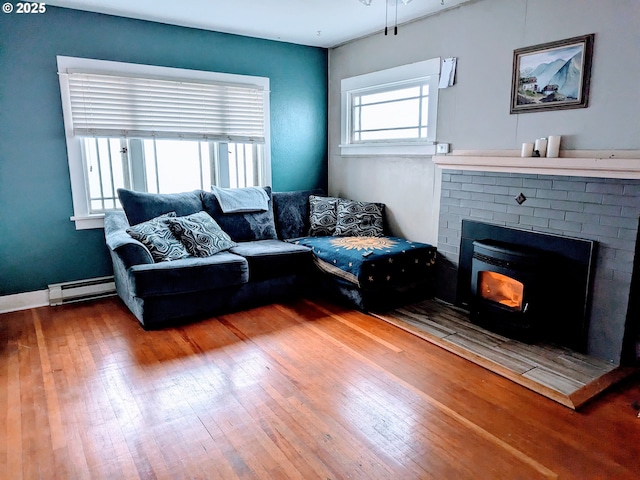 living room with hardwood / wood-style flooring and a baseboard heating unit