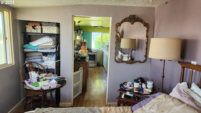 505 E 13th St, The Dalles, OR 97058 - bedroom with wood finished floors and a textured ceiling