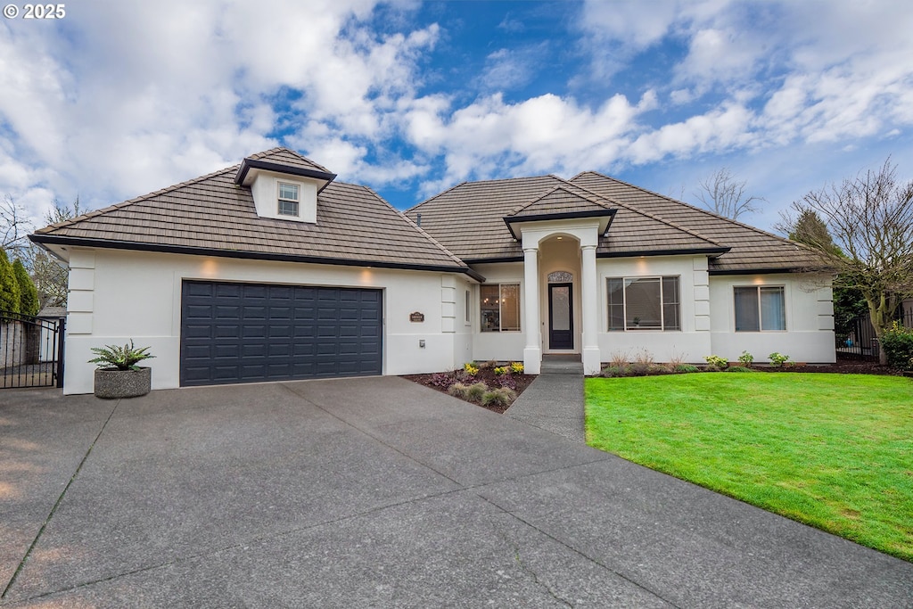 view of front of home featuring a garage and a front lawn