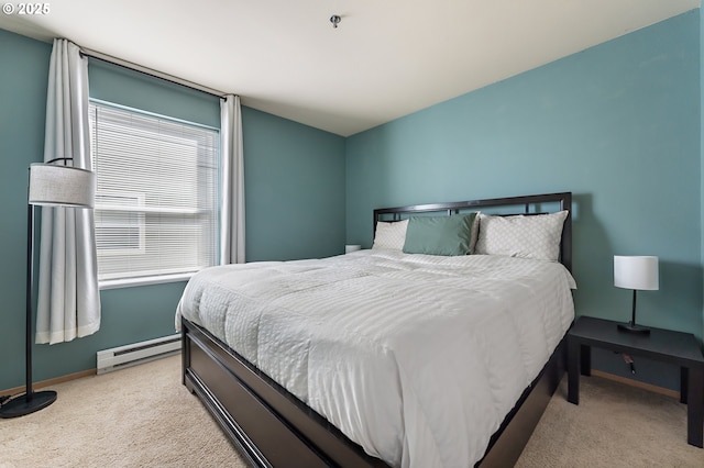 410 NW Uptown Ter Unit 3-B, Portland, OR 97210 - bedroom with a baseboard radiator, light carpet, and baseboards