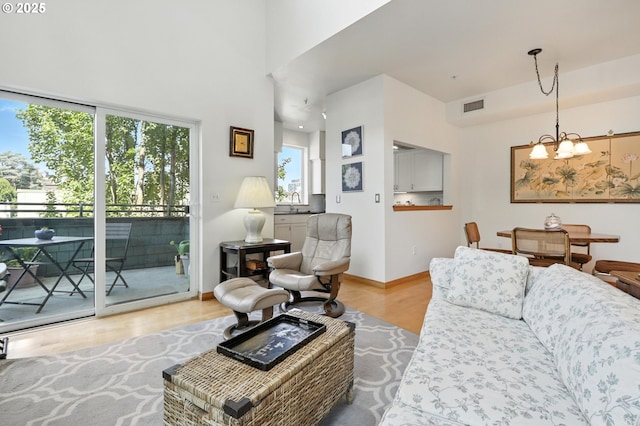 2024 SW Howards Way, Portland, OR 97201 - living area featuring a chandelier, wood finished floors, and a high ceiling