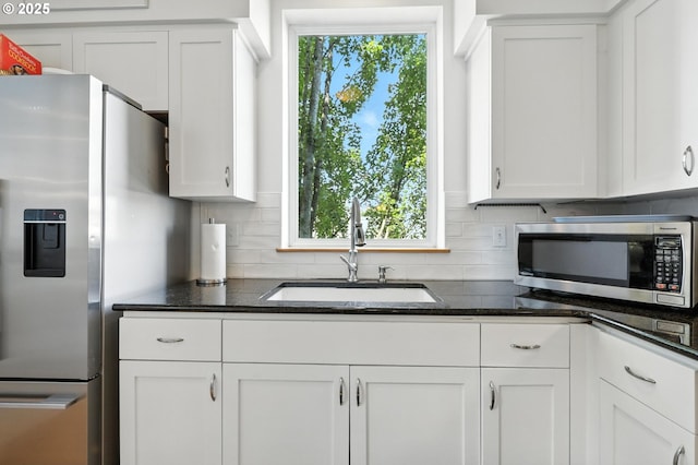 2024 SW Howards Way, Portland, OR 97201 - kitchen featuring stainless steel appliances, white cabinetry, tasteful backsplash, and healthy amount of natural light