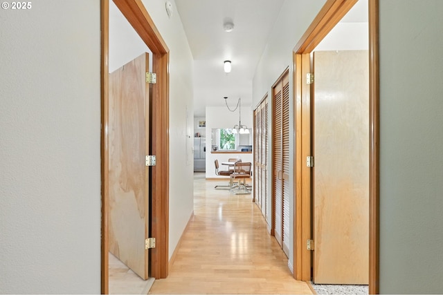 2024 SW Howards Way, Portland, OR 97201 - corridor featuring light wood finished floors and a chandelier