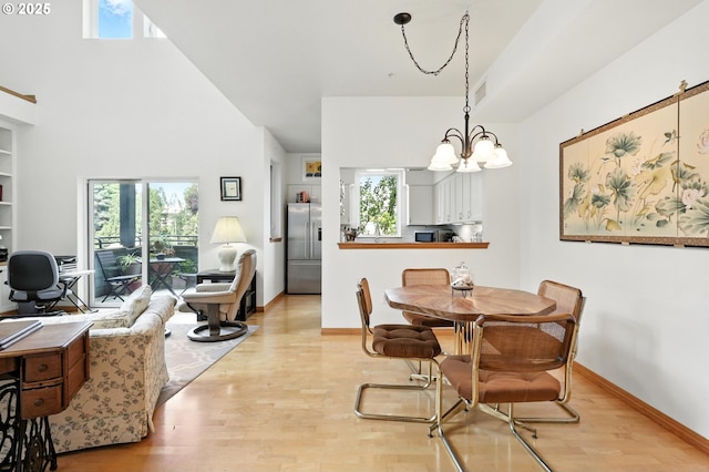 2024 SW Howards Way, Portland, OR 97201 - dining room with a chandelier, wood finished floors, healthy amount of natural light, and a high ceiling