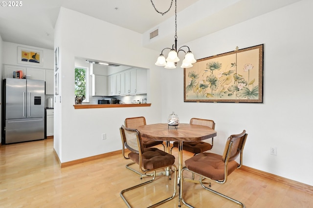 2024 SW Howards Way, Portland, OR 97201 - dining room featuring light wood-style flooring and a chandelier