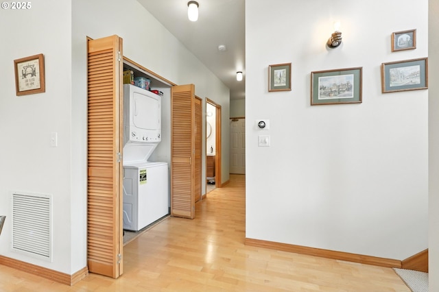 2024 SW Howards Way, Portland, OR 97201 - corridor featuring stacked washing machine and dryer and light wood-style flooring