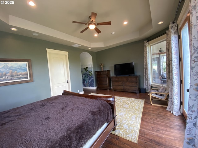 625 St Andrews Loop, Creswell, OR 97426 - bedroom with arched walkways, a tray ceiling, dark wood-style floors, recessed lighting, and a ceiling fan