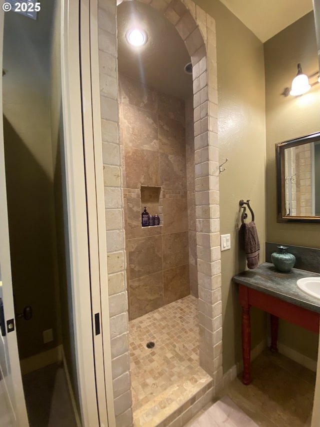625 St Andrews Loop, Creswell, OR 97426 - bathroom with tiled shower, vanity, baseboards, and tile patterned flooring