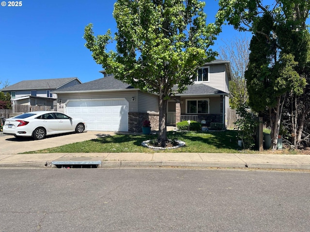 view of front facade with driveway, fence, a garage, stone siding, and a front lawn