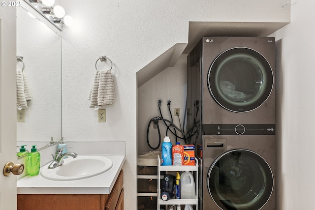 bathroom with stacked washer and clothes dryer and vanity