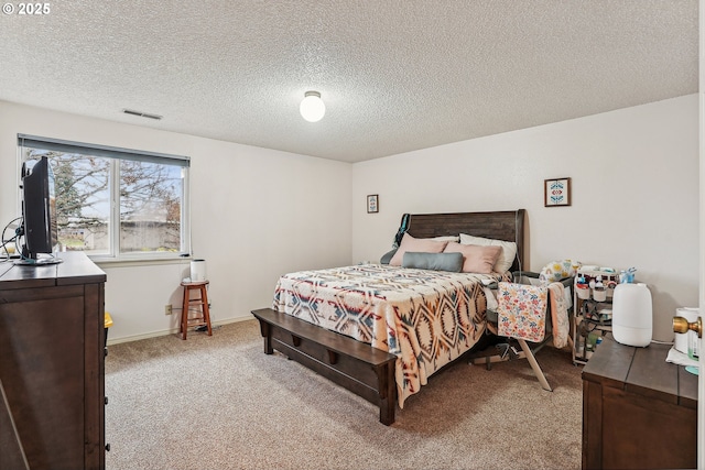 bedroom featuring light carpet and a textured ceiling