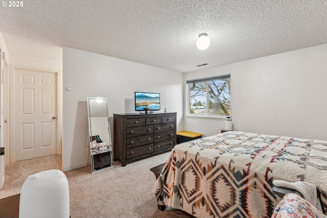 bedroom featuring light carpet and a textured ceiling